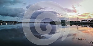 Panaromic shot of a sunrise over a seascape with a reflecton on the water