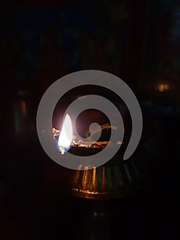 Panas ma diyo . Lighting a holi candle in oil. photo
