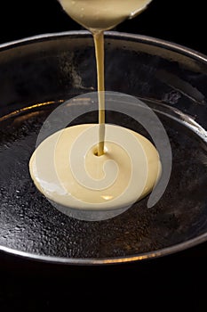 Pancake batters pouring in pan