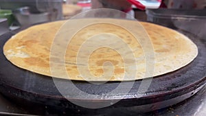 Pancake being made in street vendor shop window