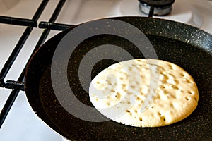 Pancake burn on the pan, homemade pancake fried in a pan in the kitchen