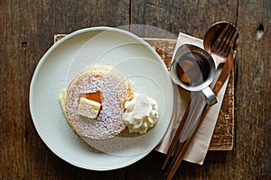 Pancake with butter and milk foam and honey