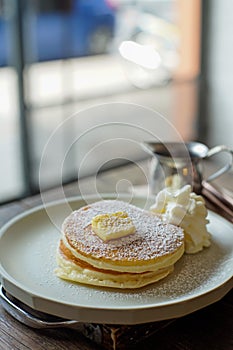 Pancake with butter and milk foam and honey