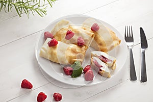 Pancake with cheese and raspberries