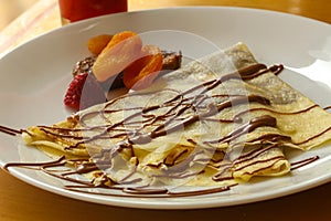 Pancake with chocolate and fruits