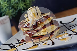 Pancake with chocolate ice-cream on plate