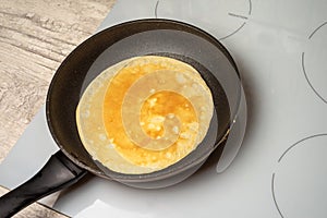 Pancake is fried in a pan
