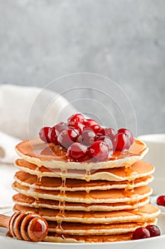 Pancake with honey and fresh berries. Cranberry, cowberry