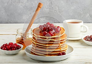 Pancake with honey and fresh berries. Cranberry, cowberry