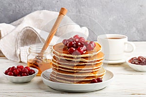 Pancake with honey and fresh berries. Cranberry, cowberry