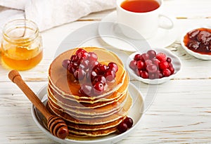 Pancake with honey and fresh berries. Cranberry, cowberry