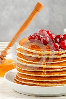 Pancake with honey and fresh berries. Cranberry, cowberry