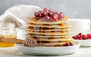 Pancake with honey and fresh berries. Cranberry, cowberry