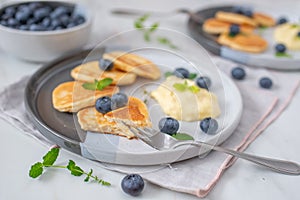 Pancake porridge, mini pancakes in a bowl with maple syrup