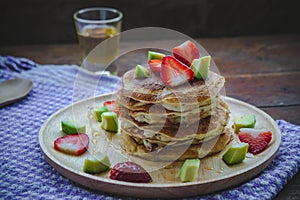 Pancake strawberry avocado fruit and honey syrup sweet dessert on wood table pan cake dessert homemade