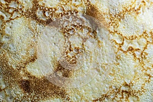 Pancake surface texture and pattern. Close-up of thin hot pancakes in a plate. Traditional rustic food. Graphic resource