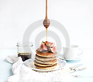 Pancake tower with fresh figs and honey on a
