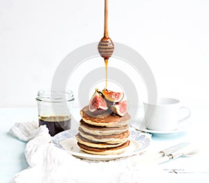 Pancake tower with fresh figs and honey on a