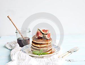 Pancake tower with fresh figs and honey on a