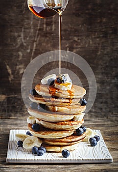 Pancakes with banana, blueberry and maple syrup.