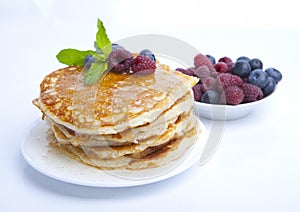 Pancakes with berries, honey and mint