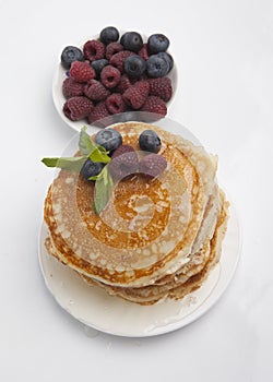 Pancakes with berries, honey and mint