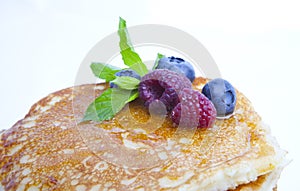 Pancakes with berries, honey and mint