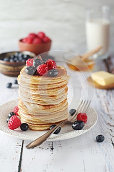 Pancakes with berries in rustic style