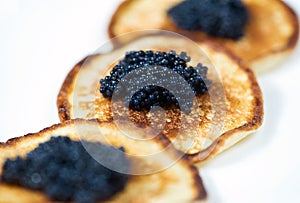 Pancakes with black caviar