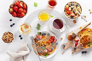 Pancakes with blueberry strawberry honey and quinoa for breakfast