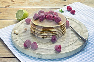 Pancakes breakfast with raspberry on wooden background