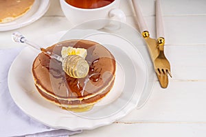 Pancakes with butter and honey or maple syrup drizzles