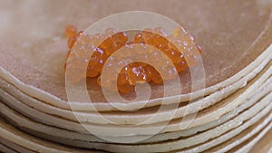 Pancakes with caviar on a plate. Traditional Russian pastry for Maslenitsa, Shrovetide.