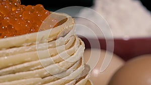 Pancakes with caviar on a plate. Traditional Russian pastry for Maslenitsa, Shrovetide.