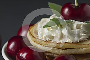 Pancakes with cherries and whipped cream