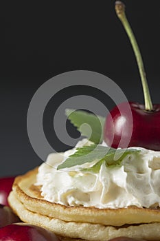 Pancakes with cherries and whipped cream