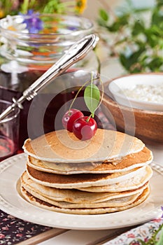 Pancakes with cherry flowers still life summer
