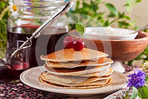 Pancakes with cherry flowers still life summer