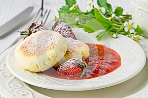 Pancakes from cottage cheese with berries, powdered sugar and fresh mint, white wooden background, breakfast