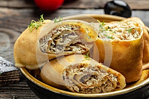 Pancakes or crepes roll with the chicken meat served on a white plate, Food recipe background. Close up