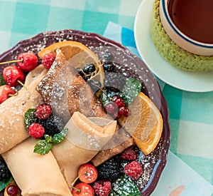 Pancakes decorated with fruits on glass table for breakfast