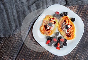 Pancakes with fresh blackberries and raspeberries, top view, horizontal