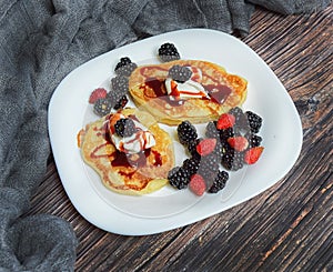 Pancakes with fresh blackberries and raspeberries, top view, horizontal