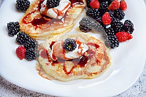 Pancakes with fresh blackberries and raspeberries, top view, horizontal