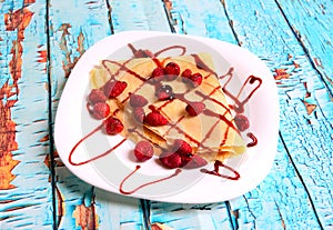 Pancakes with fresh blackberries and raspeberries, top view, horizontal