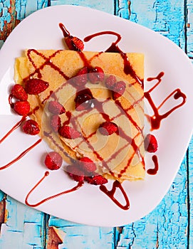 Pancakes with fresh blackberries and raspeberries, top view, horizontal