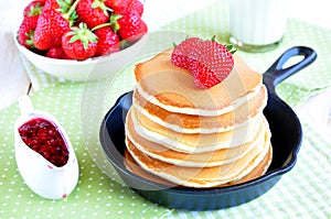 Pancakes with fresh strawberry in a small pan