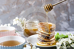 Pancakes with honey and tea for breakfast