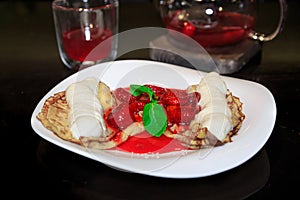 Pancakes with ice cream drizzled with strawberry and mint, teapo