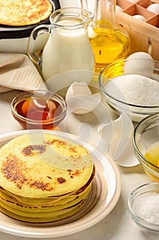 Pancakes and ingredients for making pancakes
